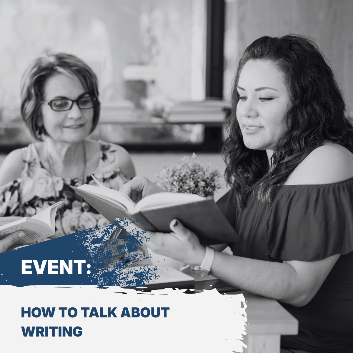 Image of two women sitting at a table looking at a book